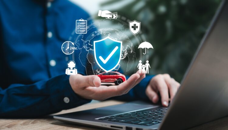 Person comparing UAE car insurance quotes online with digital icons representing protection, coverage, and vehicle safety.