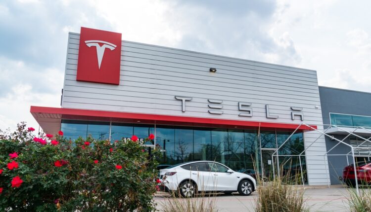 Tesla's warranty cover illustrated by a vehicle parked outside a service center