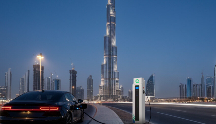 Electric car charging at a public EV station in Dubai with Burj Khalifa in the background