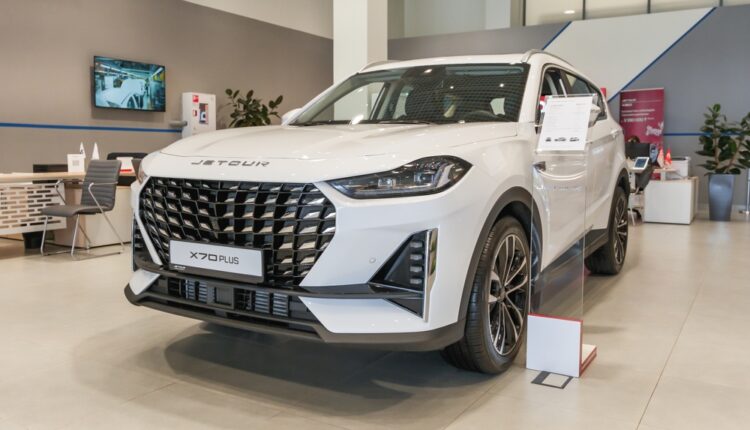 Jetour X70 Plus 7-seater SUV parked in UAE cityscape, showcasing front and side design