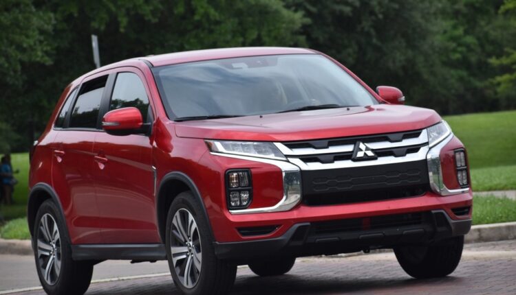 Mitsubishi Outlander SUV in red, featuring Dynamic Shield front grille, LED headlamps, and muscular styling for confident road presence.