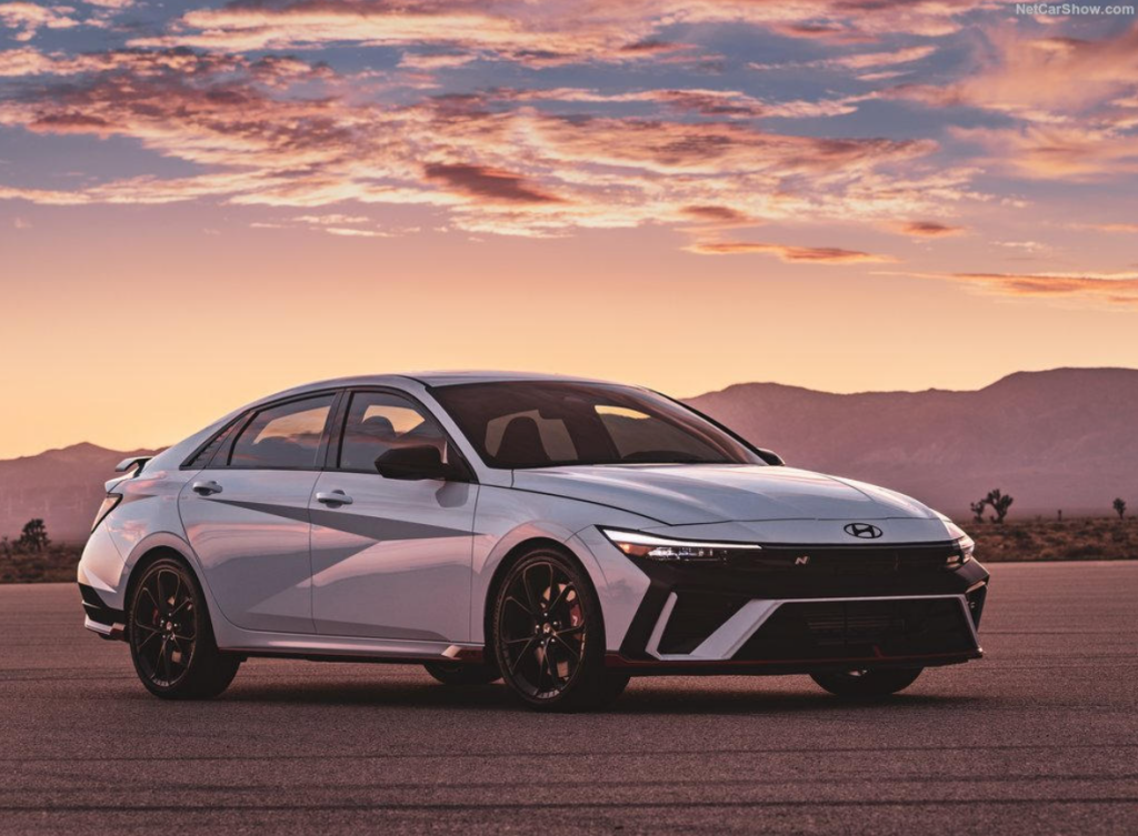2025 Hyundai Elantra exterior design with angular body lines, LED headlights, and sporty alloy wheels at sunset