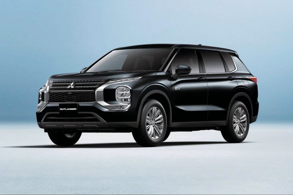 2025 Mitsubishi Outlander PHEV in black color parked in a studio setting, highlighting its modern plug-in hybrid SUV design.