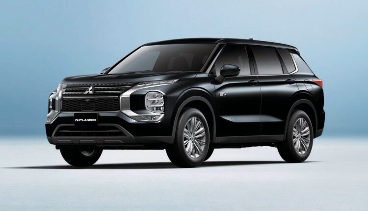 2025 Mitsubishi Outlander PHEV in black color parked in a studio setting, highlighting its modern plug-in hybrid SUV design.