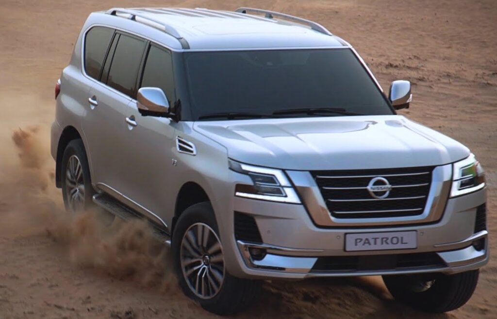 Nissan Patrol driving through desert terrain, showcasing its powerful performance and off-road capability, discussed in the blog 'Living with a Nissan Patrol: Is it a Practical Daily Driver for the City?