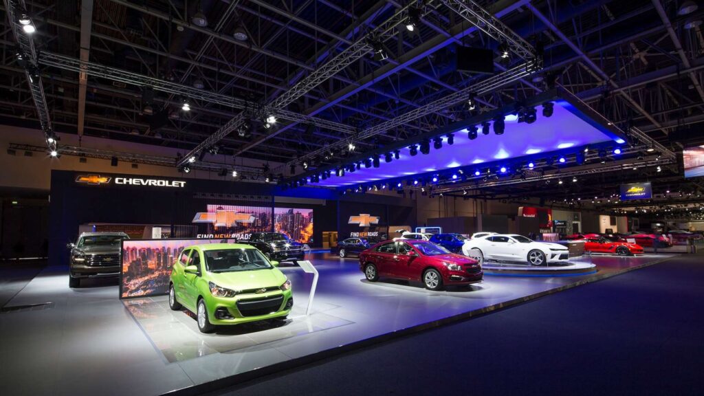 Chevrolet exhibition booth at Dubai Motor Show 2025 displaying multiple new-generation models and electric vehicles on stage at Dubai World Trade Centre.