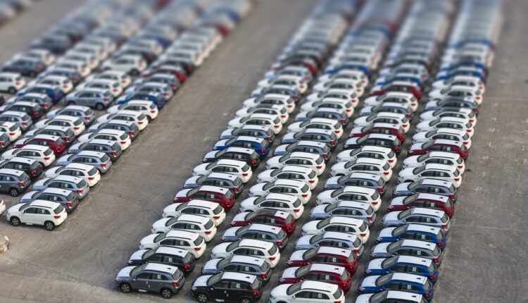 Used car market in the UAE, multiple cars parked in Dubai dealership lot ready for resale.