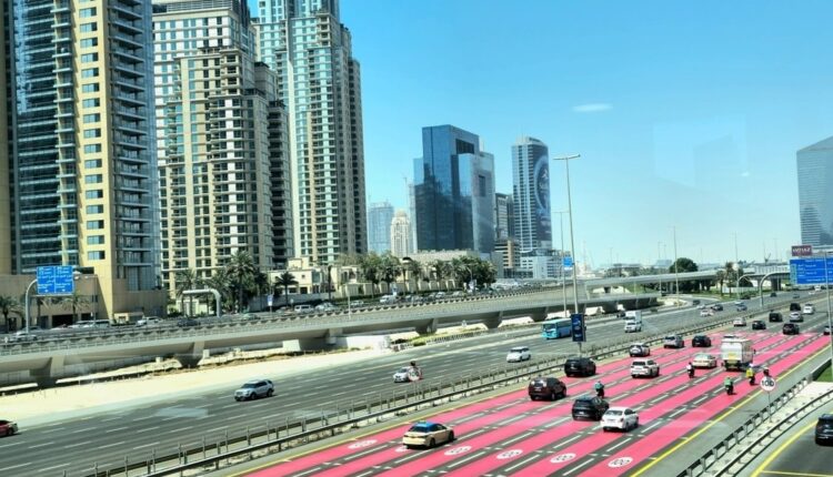 Dubai highway with clear lane markings and traffic signs, showcasing modern urban infrastructure for safe driving in the UAE.