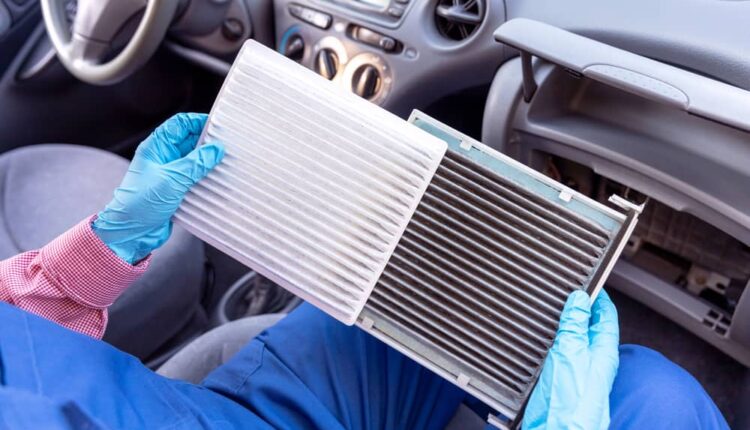 Cabin filter replacement in UAE car showing clean vs dirty filter inside dashboard