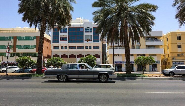A classic vintage car driving on a UAE street, illustrating the kind of vehicles eligible for classic car registration in the UAE.
