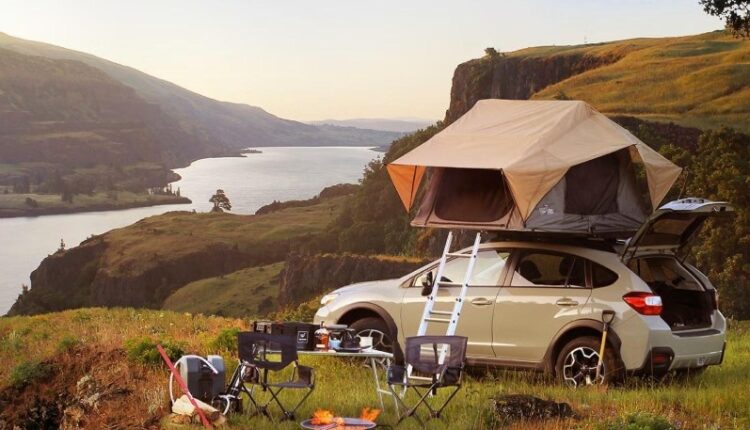 Car parked on a cliffside campsite with rooftop tent, camping chairs, and adventure gear—ideal setup showcasing essential car accessories for UAE adventurers.