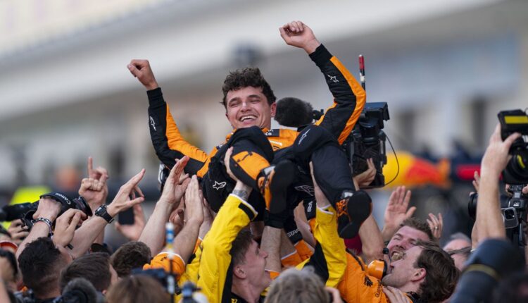 Lando Norris F1 Champion celebrated by McLaren team after title win.