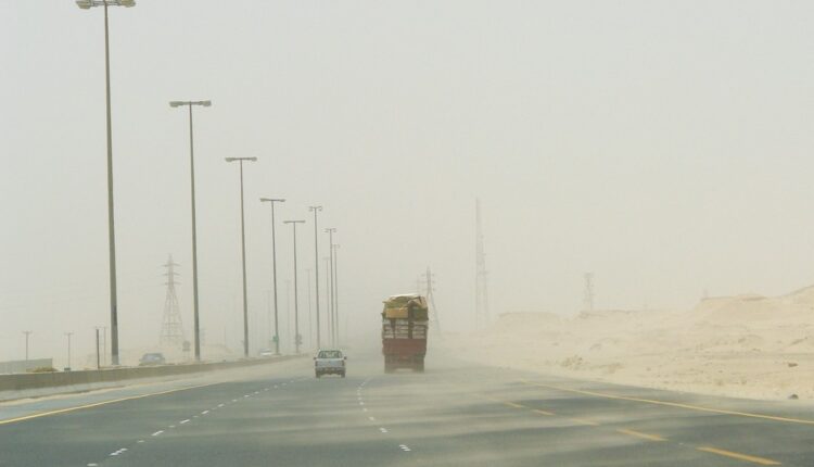 Driving safely in sandstorms and heavy winds on a dusty, low-visibility road in the desert.