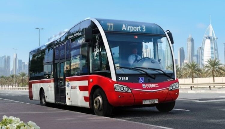 Dubai RTA bus on a city road with the Burj Khalifa and skyline in the background.