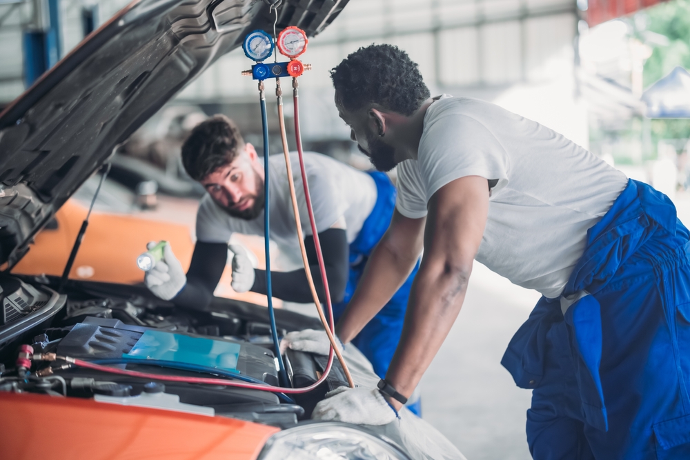 Mechanic inspecting an underhood used car in the UAE