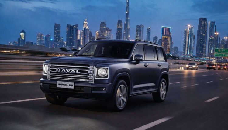 2026 HAVAL H9 UAE review image showing the SUV driving on Sheikh Zayed Road in Dubai with the Burj Khalifa skyline at dusk