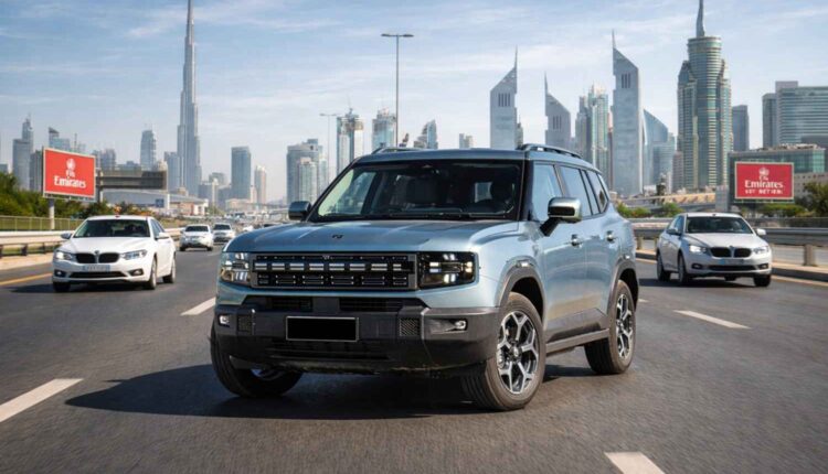 Front view of a light blue 2026 Jetour T1 driving on Sheikh Zayed Road in Dubai, surrounded by traffic with the Burj Khalifa and city skyline in the background.