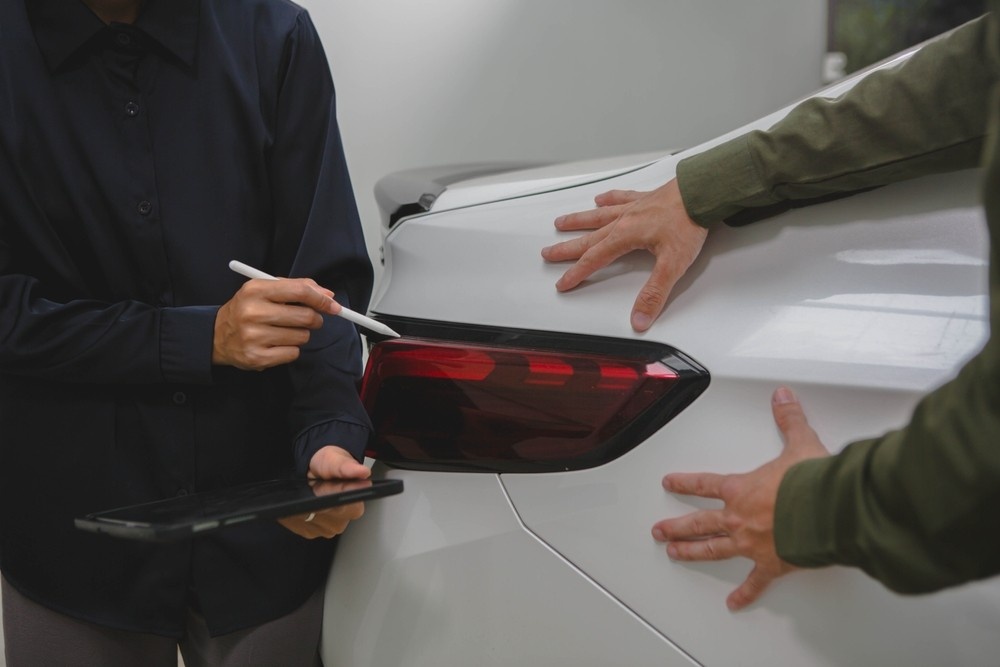 Buyer checking used car exterior body condition and panel gaps before purchase in the UAE