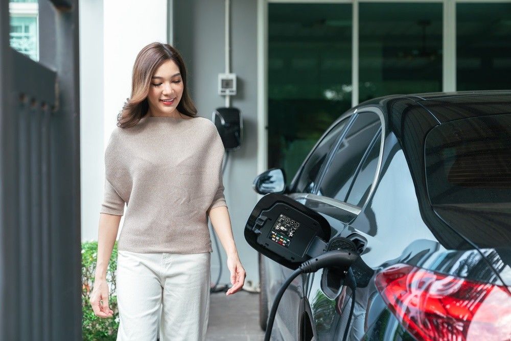 Electric car owner charging EV at home in UAE|Arabwheels.ae
