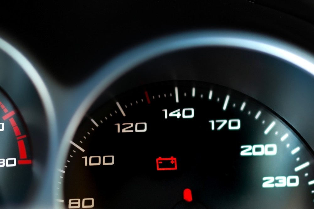 Multimeter showing weak car battery voltage during inspection| arabwheels.ae
