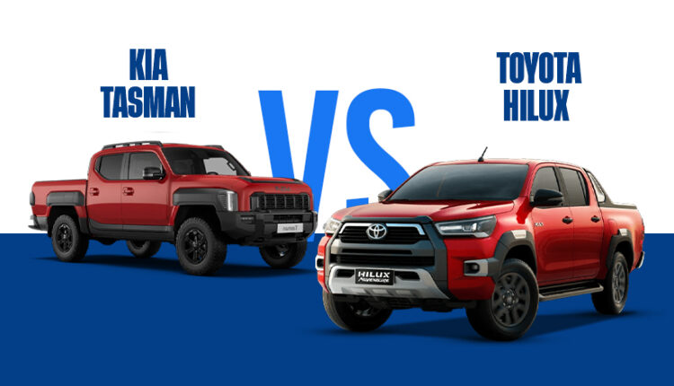 A side-by-side comparison image featuring a red Kia Tasman pickup truck on the left and a red Toyota Hilux Adventure pickup truck on the right, separated by a large blue "VS" text against a split white and blue background.|Arabwheels.ae