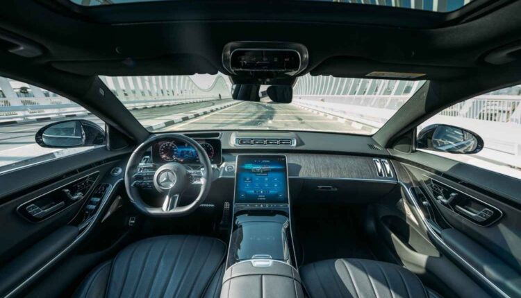 Luxury car interior with panoramic sunroof, leather seats, digital dashboard, and advanced technology features that affect premium car resale value in UAE.