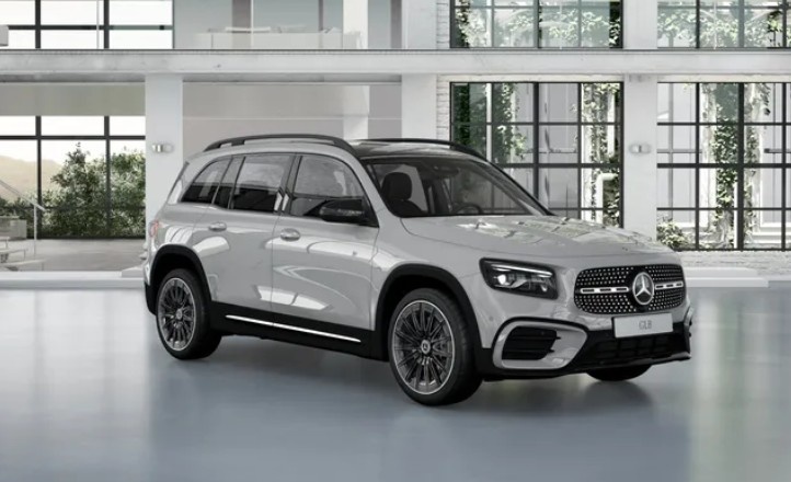 White Mercedes-Benz GLB 250 4MATIC SUV shown from the front-side angle inside a bright, modern showroom.|Arabwheel.ae