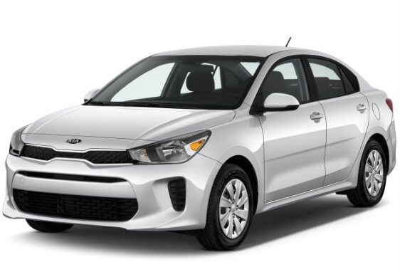 Silver Kia Rio sedan shown from the front side| Arabwheels.ae