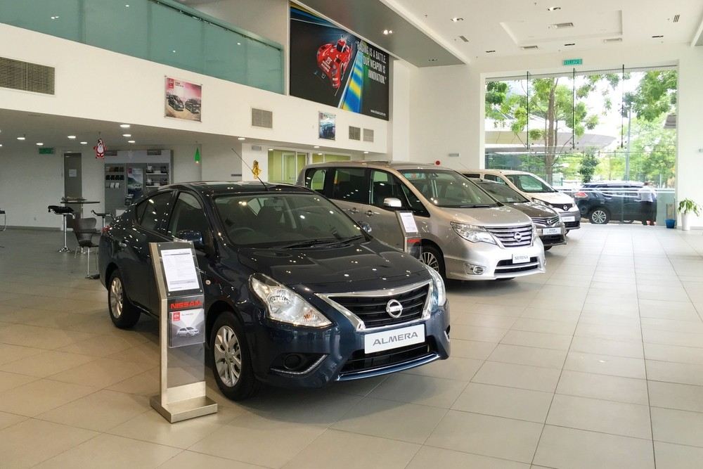 Nissan cars displayed inside a modern showroom.|Arabwheels.ae