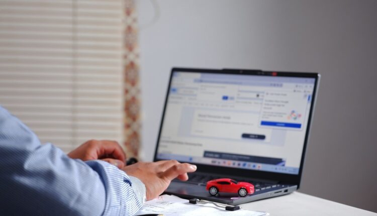 Buyer comparing used cars online on a laptop in the UAE|Arabwheels.ae